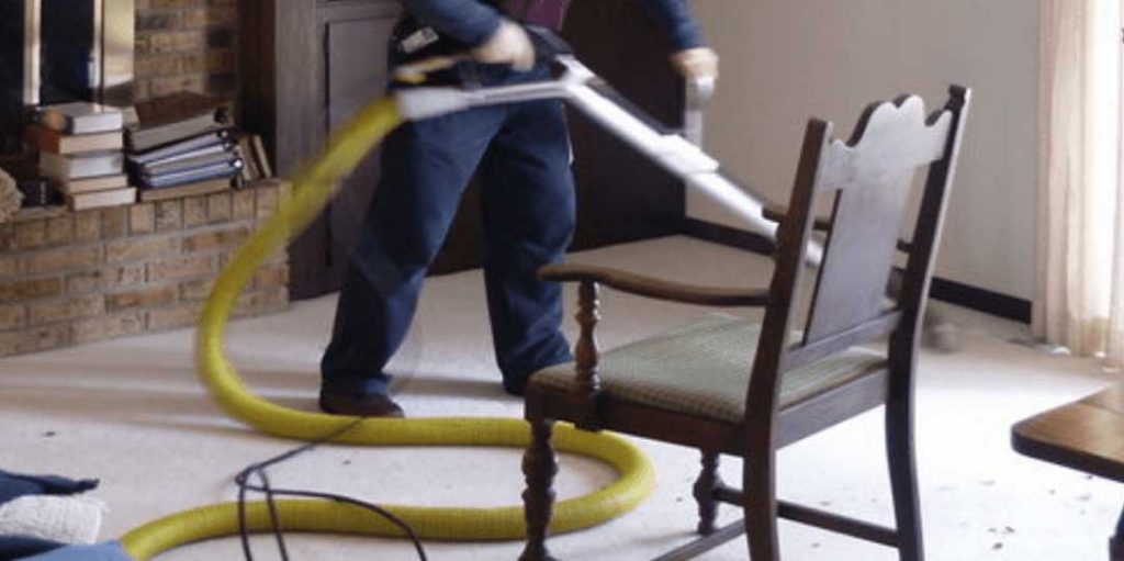 Pixies employee cleaning carpet with professional equipment