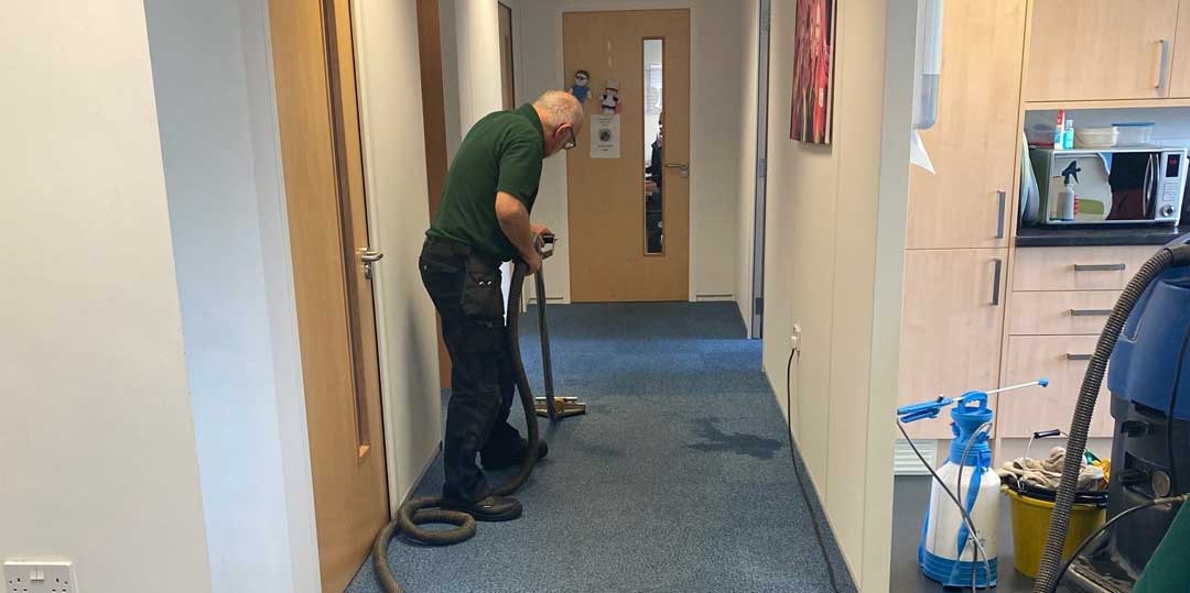 Paul cleaning a carpet